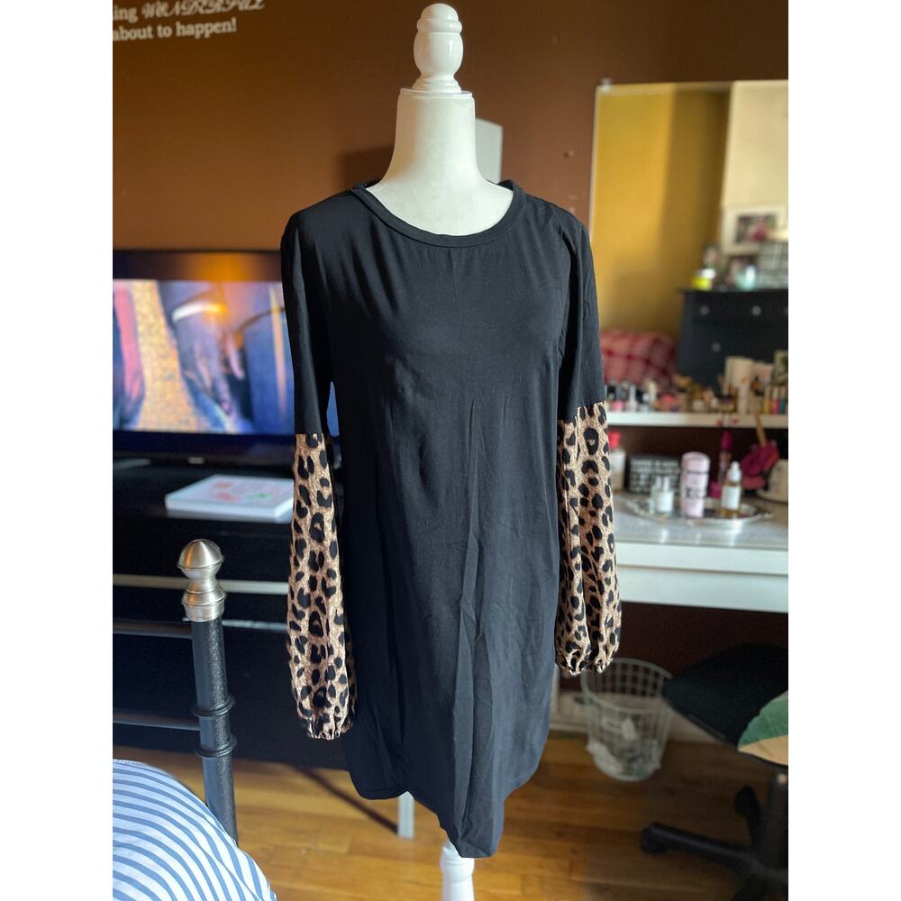 BLACK KNEE LENGTH DRESS WITH CHEETAH PRINT SLEEVES. IN GOOD CONDITION.